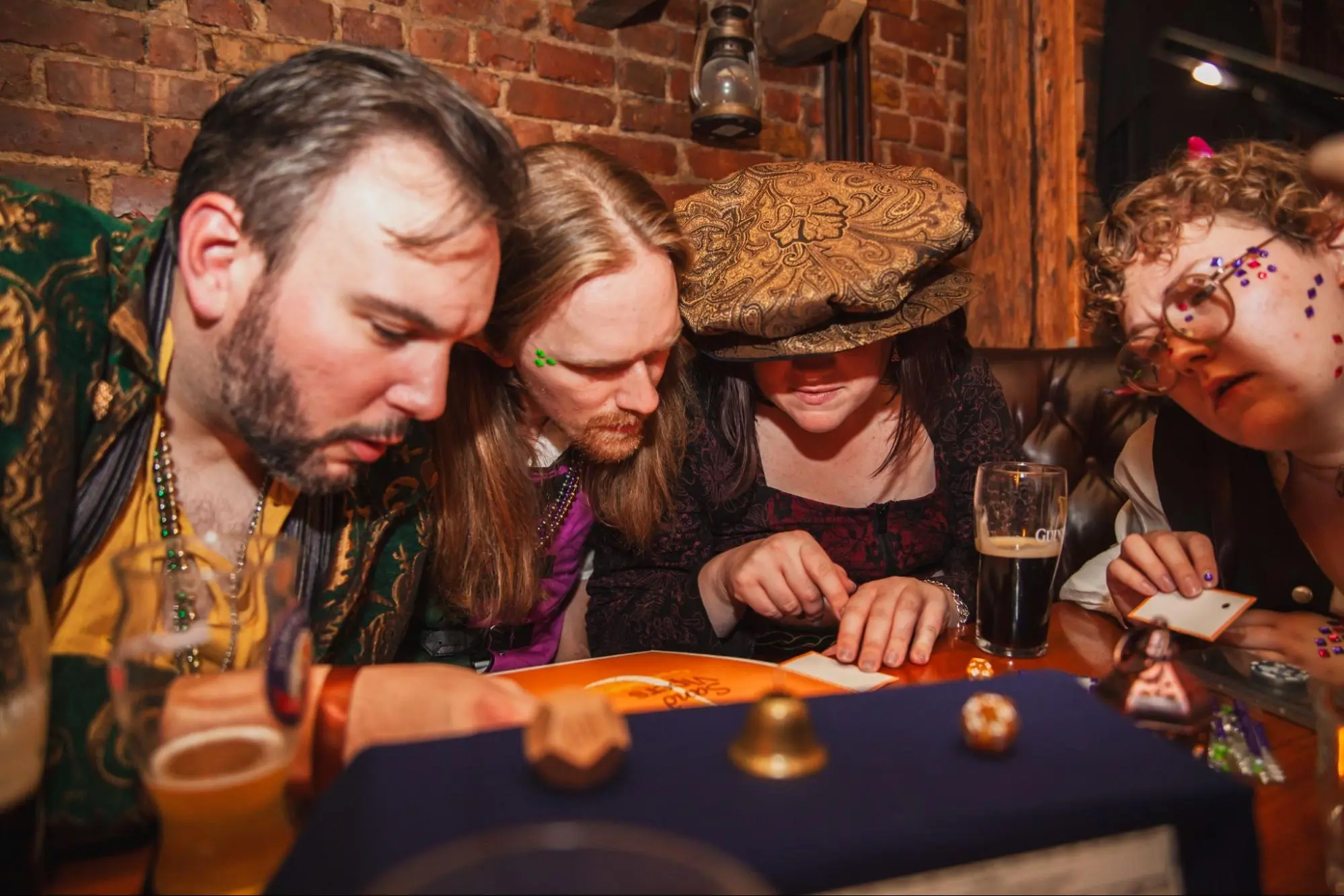 Players in costume gathered around a candlelit table, fully immersed in a session
