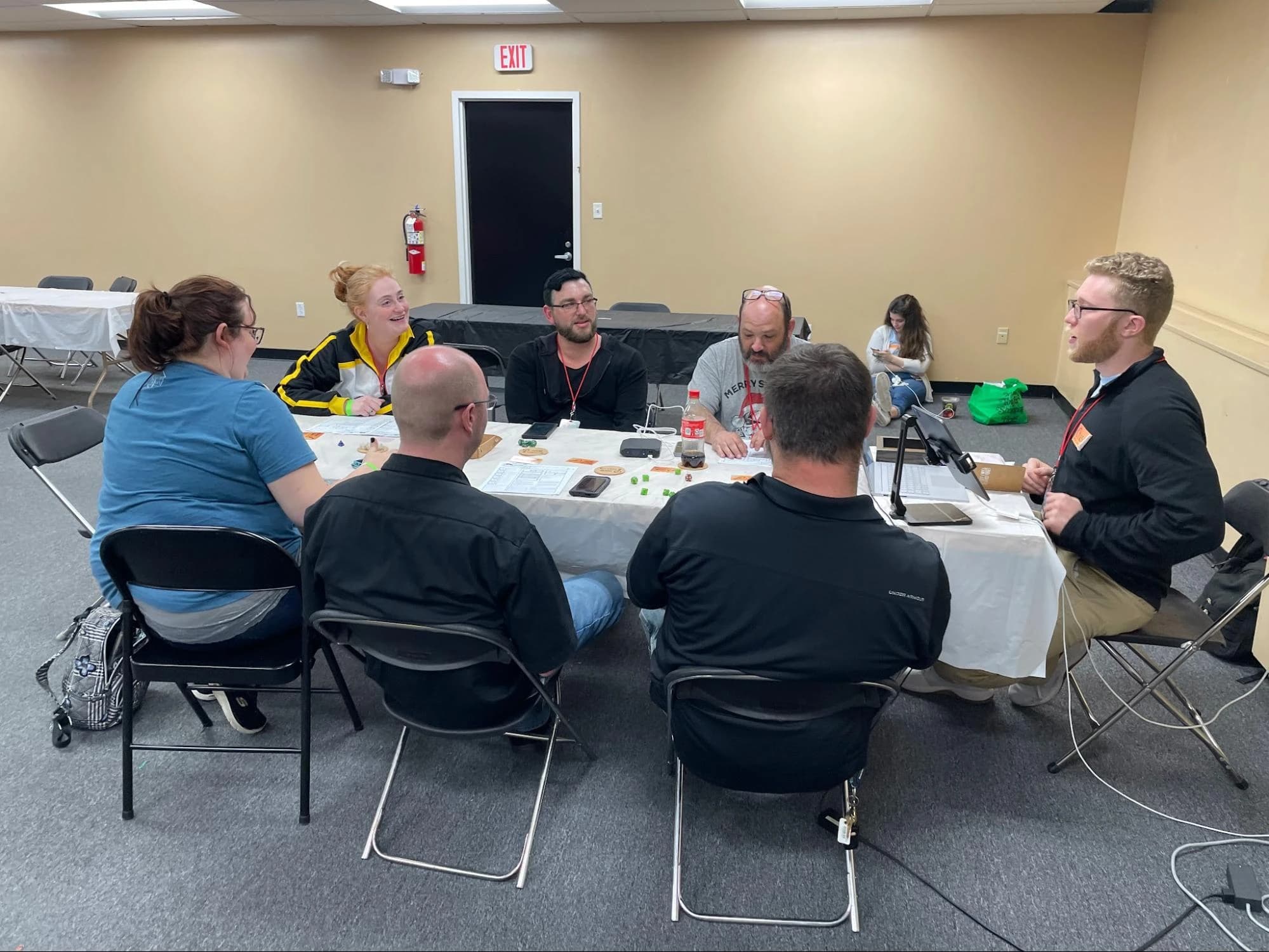 Players gathered around a table for a tabletop session at an event