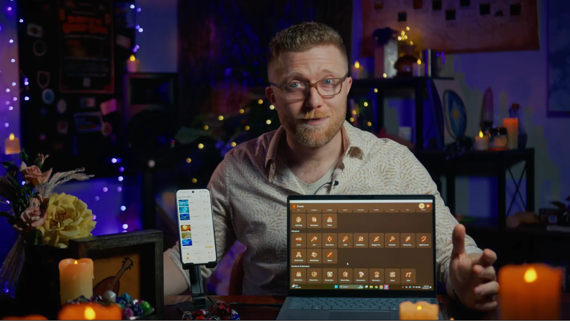 Chase on camera discussing the Pocket Bard desktop app, with a phone and laptop on the table