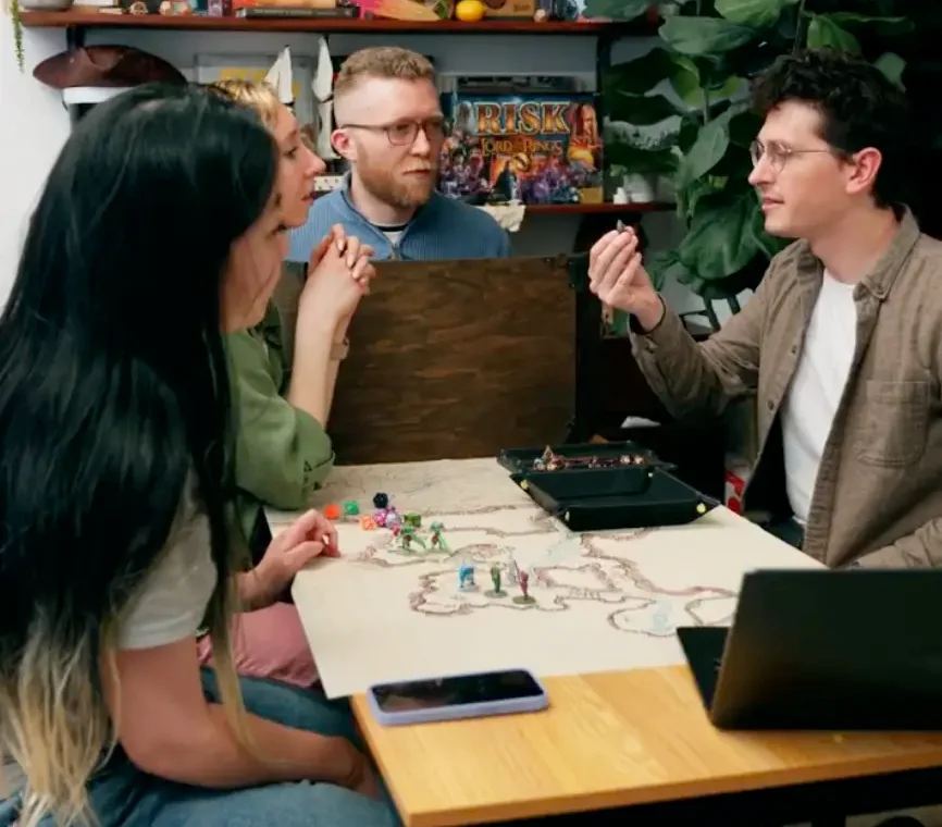 A game master and players gathered around a hand-drawn map mid-session